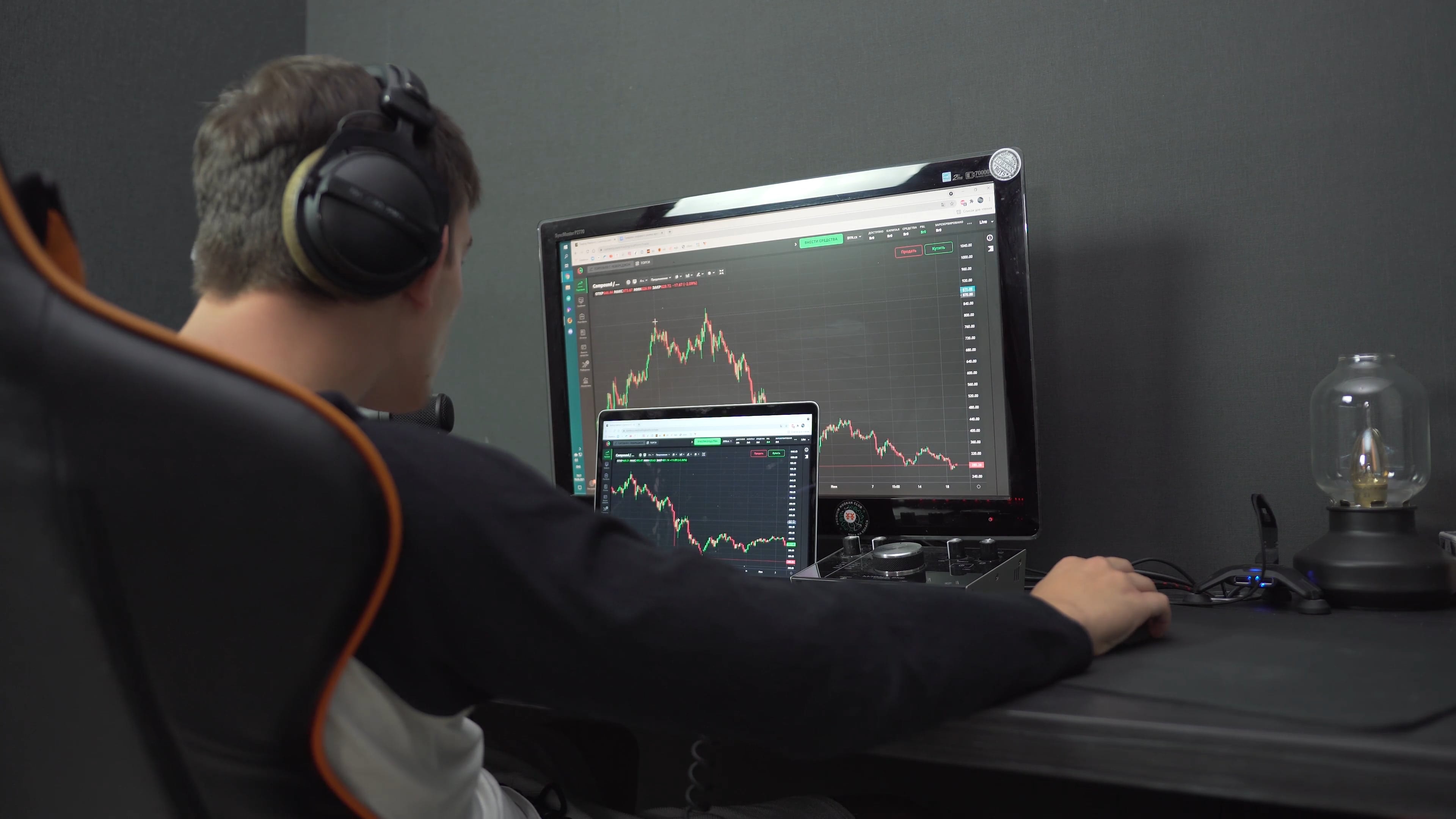 Person in front of a computer looking at a down market chart. PD from pexels.com