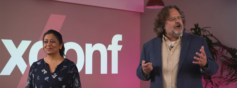 Nimisha Asthagiri and Scott Davis on stage, speaking at xconf